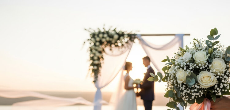 Woman and man getting married outdoors at sunset. Bridal couple under arch for wedding ceremony with bouquet for invitation card.
