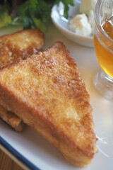 Delicious golden fried toast with honey and cream
