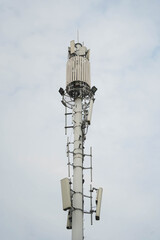 Global 5G network infrastructure: high-speed wireless communication tower under cloudy sky