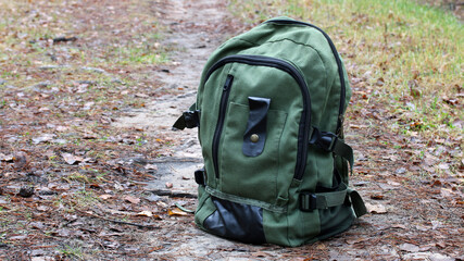 Backpack standing on forest trail for outdoor adventure