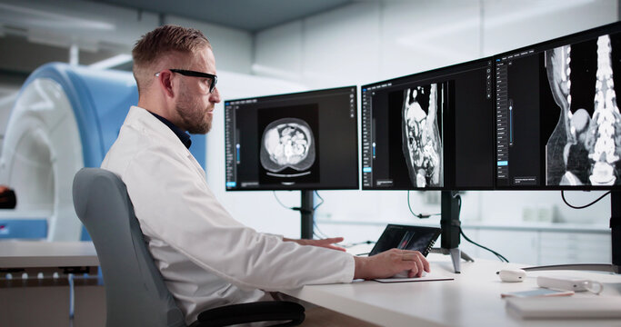 Young Male Surgeon Analyzing Lumbar MRI Scan