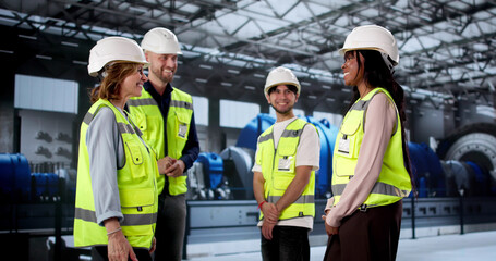 Workers Shaking Hands At Power Plant Facility, Sealing New Agreement