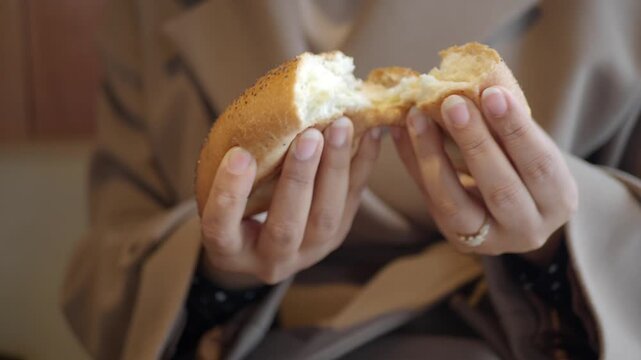 A bread roll being broken apart