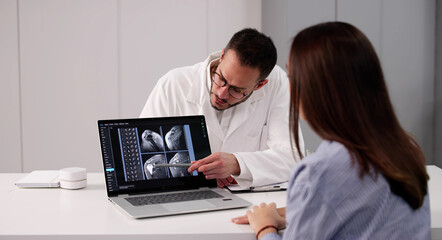 Medical Professional Showing X-ray Images To Patient