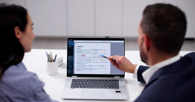 Skilled Editor Reviews Manuscript For Errors On Computer