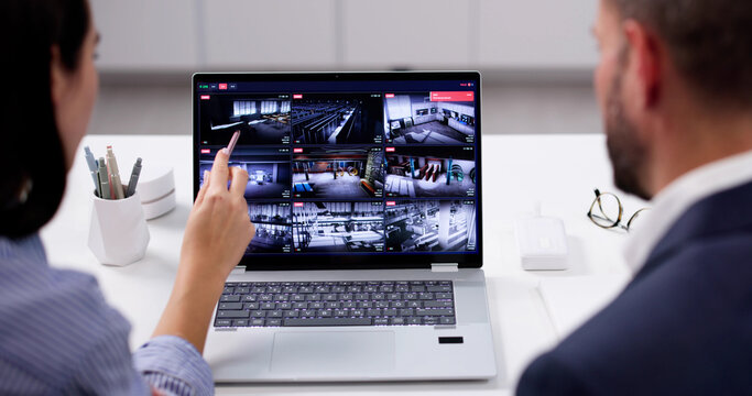 Focused Security Guard Watches CCTV Surveillance Video Footage