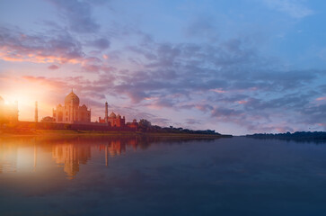 Naklejka premium Taj Mahal mausoleum reflected in Yamuna river at sunset - Agra, Uttar Pradesh, India
