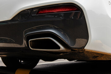 Fototapeta premium Rear view showcases the car's exhaust, taillight, and the vehicle's body.