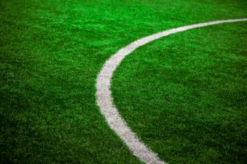 Photo of a green synthetic grass sports field with white line shot from above. 8K Resolution. Great to use as a background. Copy space image.