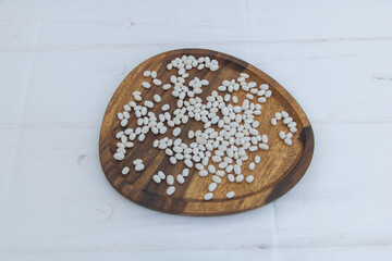 White beans on wooden plate - organic food