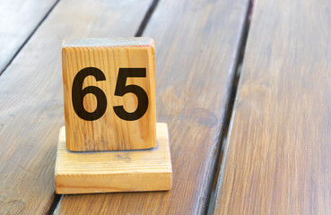 Wooden priority number 65 on a plank tab