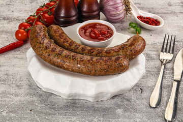 Grilled beef sausages with sauce