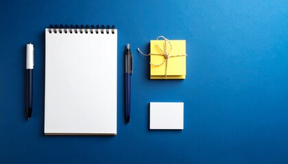 Black Pen and Blank Spiral Notepad on Dark Blue Surface