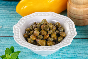 Pickled canned capers in the bowl