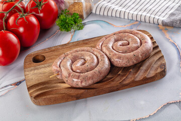 Raw meat pork and beef swirl sausages