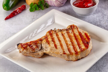 Tasty hot grilled bone steak served sauce