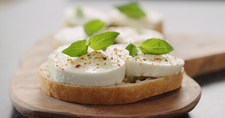 bruschetta with pesto and mozzarella on olive board