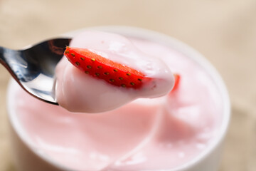 eat strawberry yogurt in white bowl closeup shot