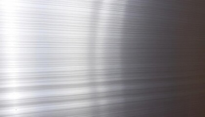 Close-up of brushed steel, showing fine parallel lines and subtle highlights, backdrop, worn