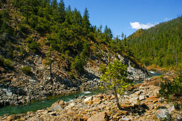Mountain landscape with Smith river, rocks, and conifer forest in Northern California