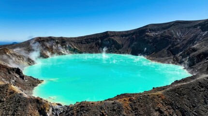 Stunning Turquoise Crater Lake with Volcanic Landscape Under Clear Blue Sky.