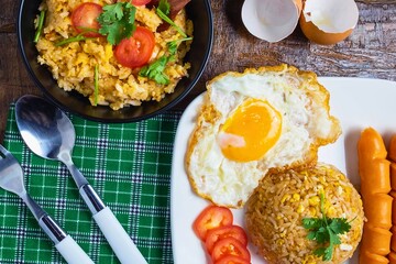 Hearty breakfast plate with fried egg noodles and sausages