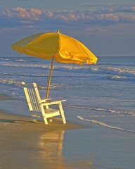 Empty Beach Scene With Yellow Umbrella And White Chair