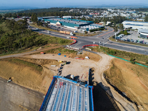 Roads and bridge under construction with industrial area buildings and workshops