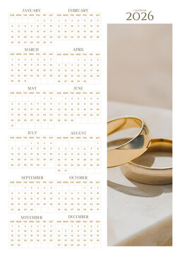 2026 yearly wall calendar with elegant gold wedding rings, minimal romantic theme, clean monthly grid layout, and printable planner design.