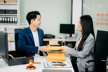 justice and law concept.passing bribe money in the envelop at lawyer office.