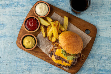 Smash burger with cheddar cheese and caramelized onions, served with fries
