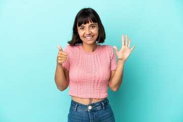 Young mixed race woman isolated on blue background counting six with fingers