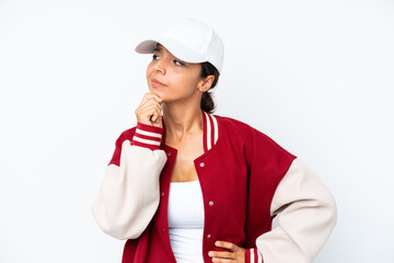 Young hispanic woman wearing a baseball uniform isolated on white background having doubts and thinking