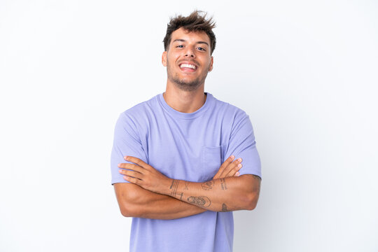 Fototapeta Young caucasian handsome man isolated on white background keeping the arms crossed in frontal position