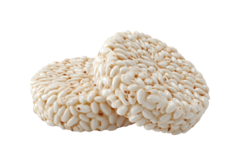 Two beige rice cakes stacked on a plain, dark background