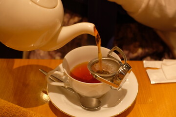pouring tea into tea cup
