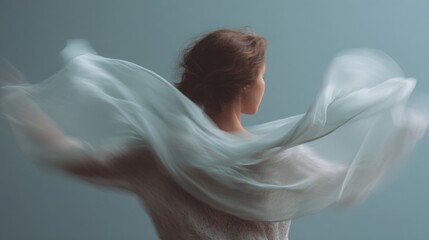 Woman with her back to the camera, facing away from the viewer. she is wearing a white dress with a floral pattern and her hair is styled in loose curls.
