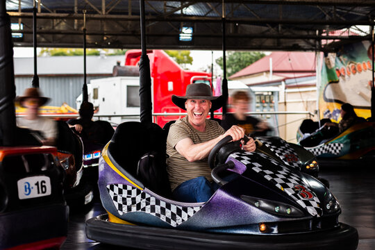 Bumper cars ride with Aussie man riding dodgem car at carnival show ride smiling