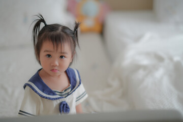 Cute baby lying on bed in soft natural light