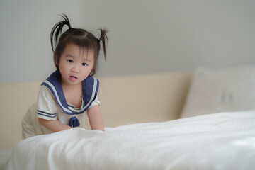 Cute baby lying on bed in soft natural light