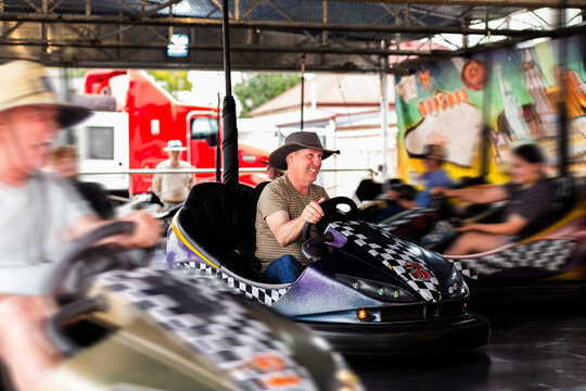 Bumper cars ride with Aussie man riding dodgem car at carnival show ride smiling