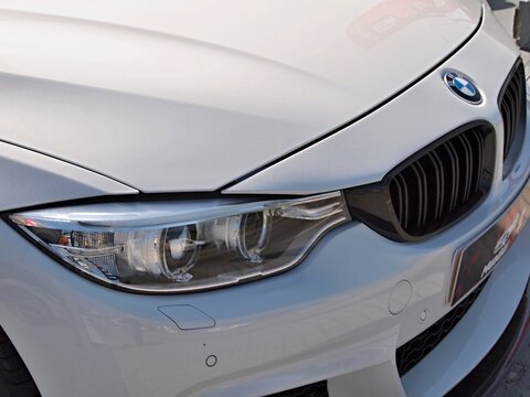 BMW white car front headlight grille detail
