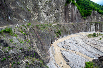 The Girdimanchay River flows through a rugged canyon near Lahij, Azerbaijan, surrounded by cliffs and rocky terrain.