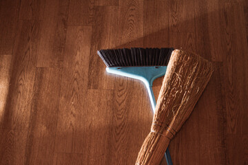 broom and broom close-up with dust and dirt while cleaning the room