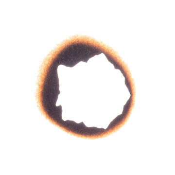 Paper sheet with irregular burnt hole and dark scorch marks, isolated on white background with clipping path.