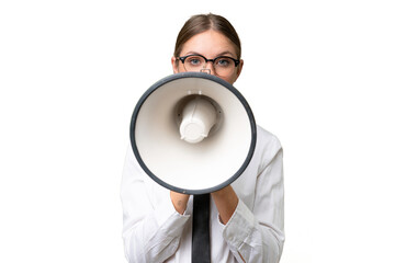 Naklejka premium Young business caucasian woman over isolated background shouting through a megaphone