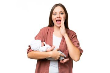 Young blonde woman  with her newborn baby over isolated chroma key background shouting with mouth wide open