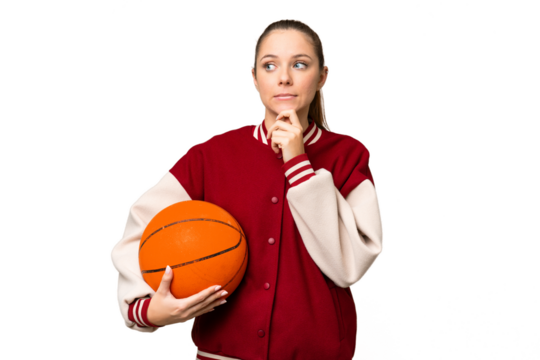 Young blonde woman playing basketball over isolated chroma key background having doubts and thinking