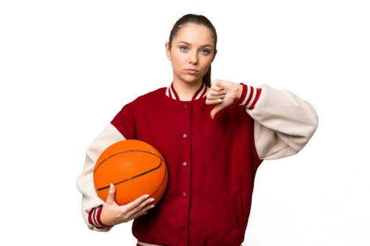 Young blonde woman playing basketball over isolated chroma key background showing thumb down with negative expression