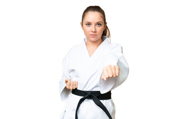 Young blonde woman over isolated chroma key background doing karate © luismolinero